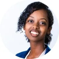 A young woman in a blue blazer is smiling, reflecting an increase in customer lifetime value.