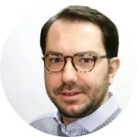 A man wearing glasses and a sweater, expertly implementing strategies to increase customer lifetime value.