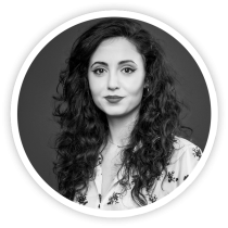 Our team's black and white photo of a woman with curly hair.